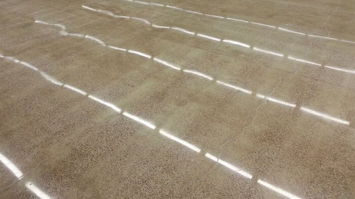 concrete floor reflecting florescent lights.